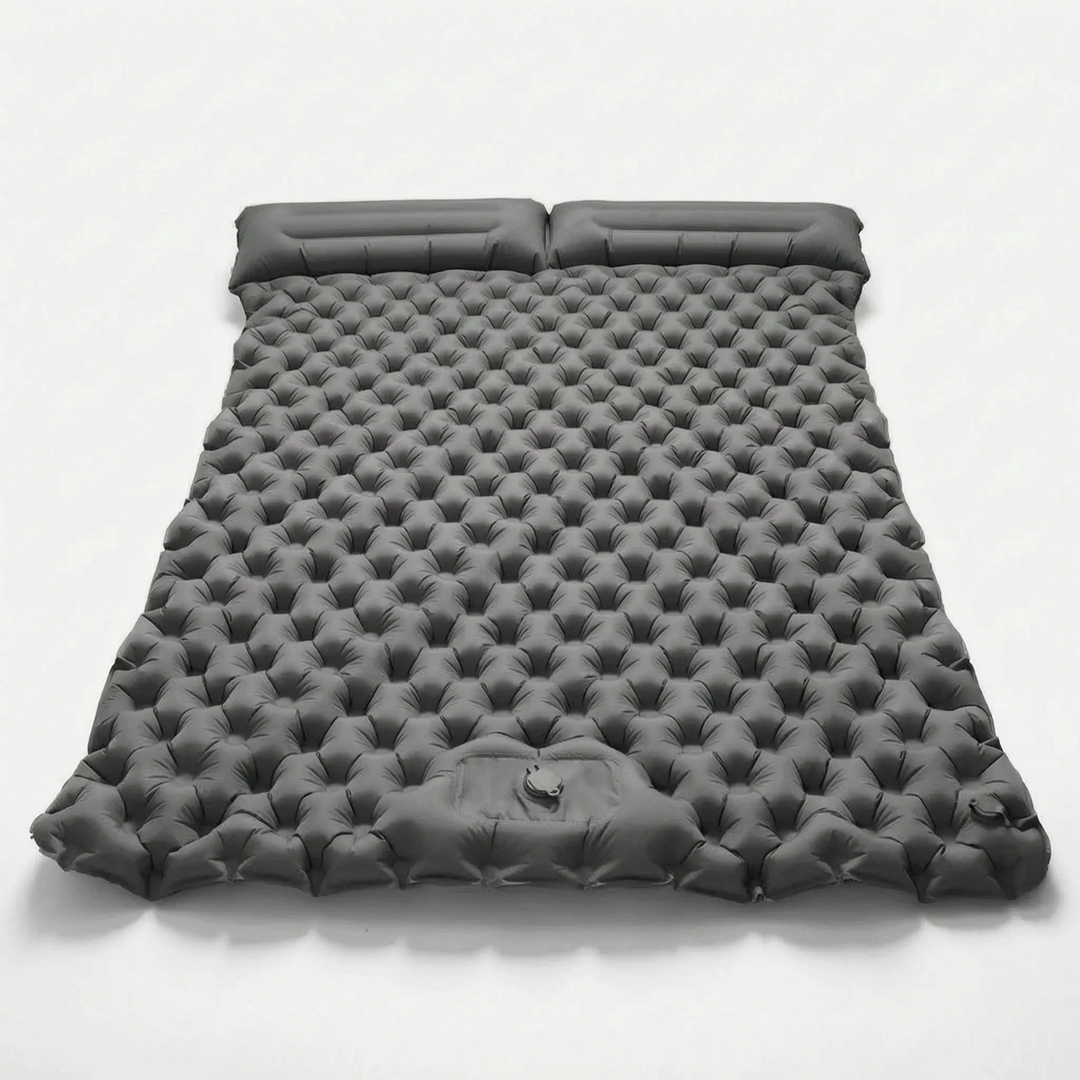 Inflatable two-person camping mattress, compact and comfortable for outdoor sleeping and backpacking.