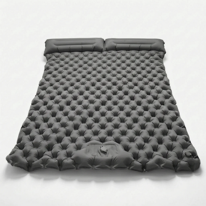 Inflatable two-person camping mattress, compact and comfortable for outdoor sleeping and backpacking.