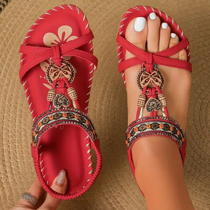 Decorated women's Boho flat T-strap sandals, featuring stylish embellishments for comfortable summer wear.