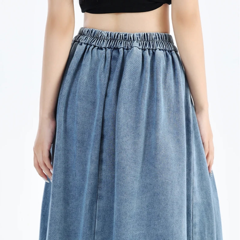 Relaxed fit blue denim midi skirt for women, offering comfortable everyday style with an elastic waistband.