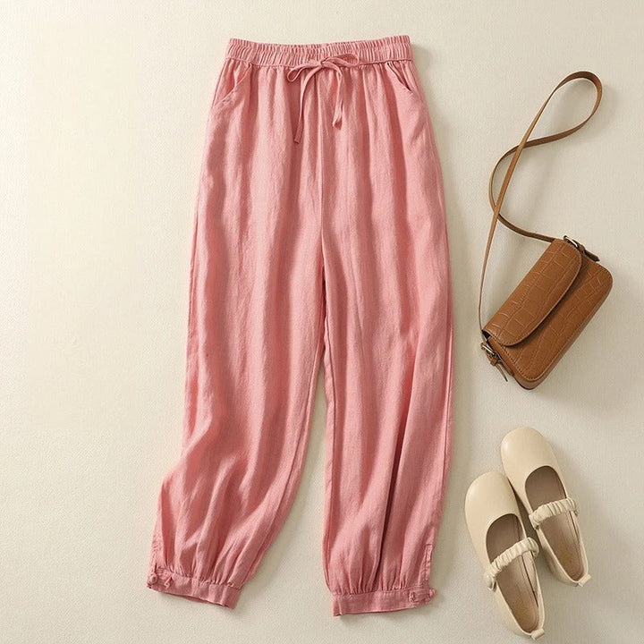 Stylish women's relaxed fit olive harem pants. Versatile with an elastic waist, ideal for comfortable summer fashion.