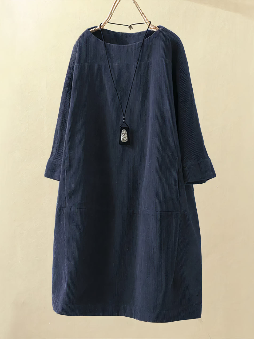 Elegant long-sleeve midi dress for women, featuring convenient pockets. Ideal for casual or modest fall fashion.