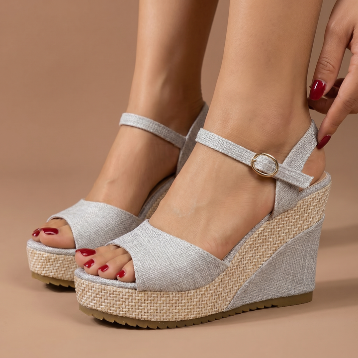 Spring/summer women's wedge heels with an ankle strap, offering comfortable and dressy footwear.