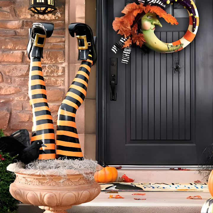 Comical witch leg stakes in striped stockings & buckled shoes, perfect funny outdoor Halloween yard decor.