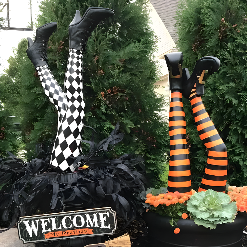 Funny Halloween decor: colorful witch legs stuck in ground stakes. Perfect comical outdoor yard & garden decoration.