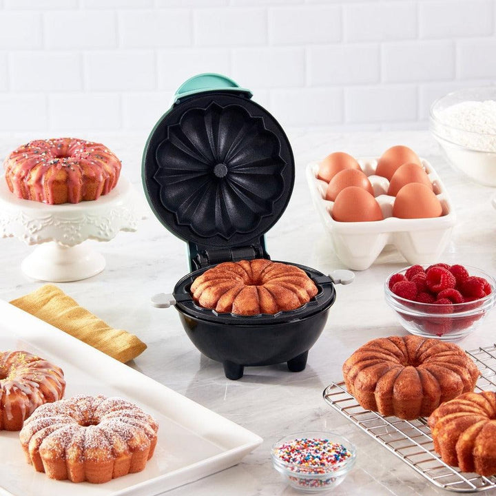 Compact BakeEase electric cake maker, perfect for quick, easy home baking. Non-stick surface.