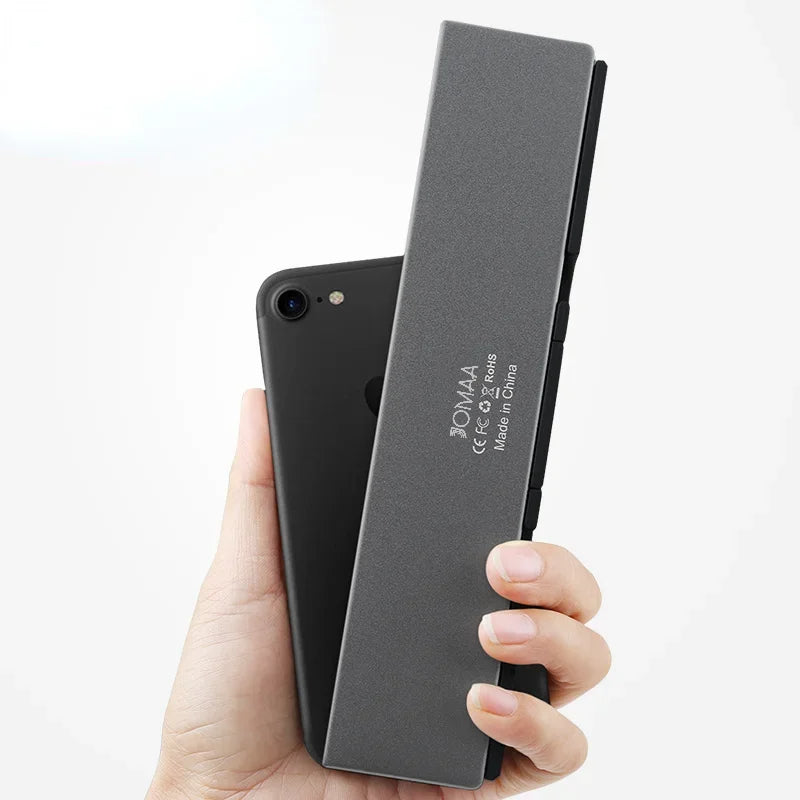 Unfolded universal Bluetooth keyboard ready for use. Connects wirelessly to any tablet or smartphone, boosts productivity.