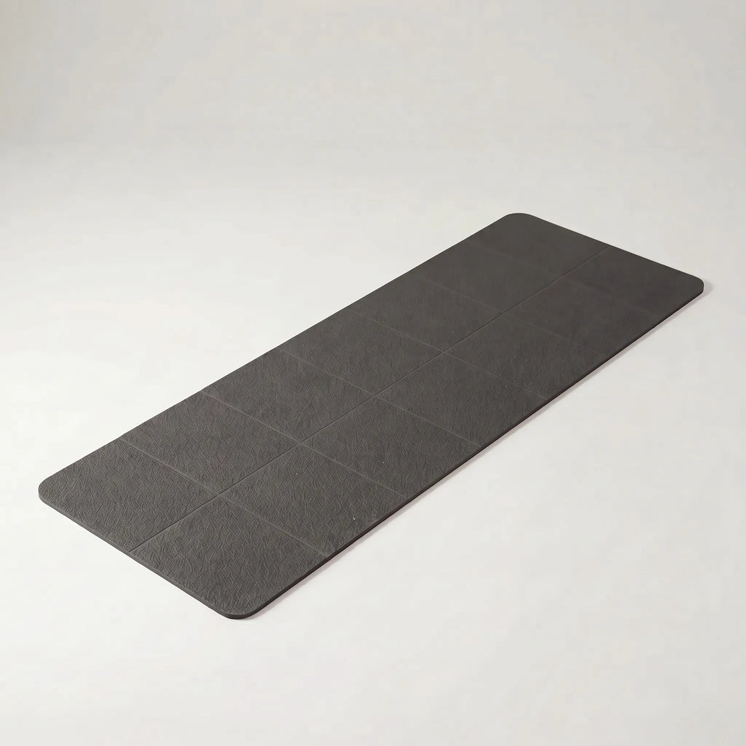 Essential compact foldable travel yoga mat for active lifestyles. Non-slip TPE surface for portable yoga, pilates & fitness.