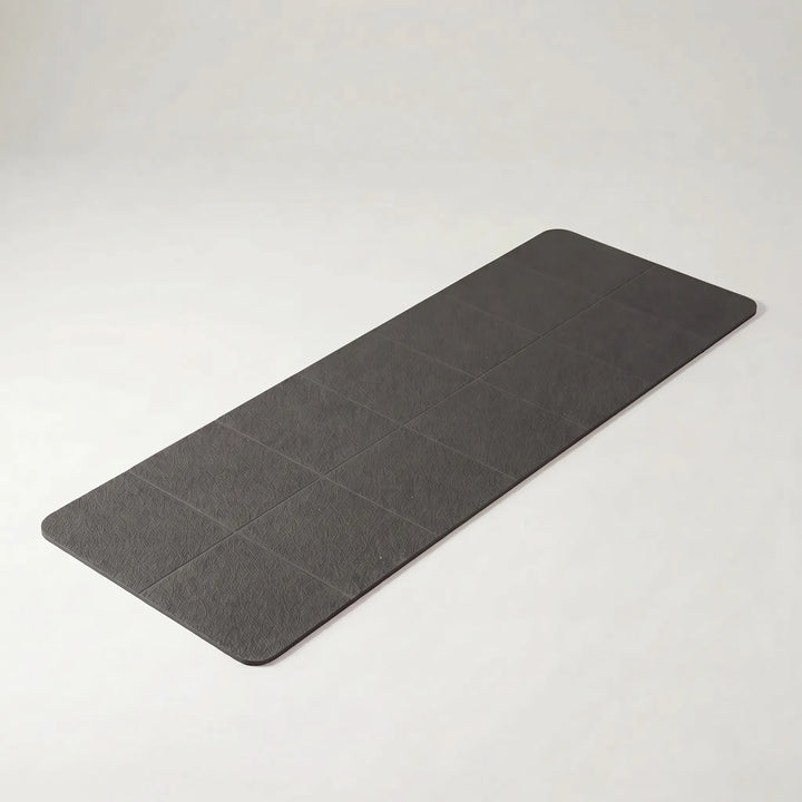 Essential compact foldable travel yoga mat for active lifestyles. Non-slip TPE surface for portable yoga, pilates & fitness.