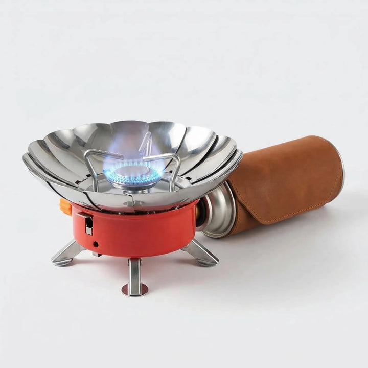 Compact folding windproof camp stove for efficient outdoor cooking. Portable burner, essential hiking gear for backpacking.