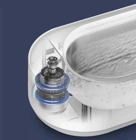 Modern ultrasonic cleaner device removing dirt from jewelry, eyeglasses & small items with powerful vibrations.