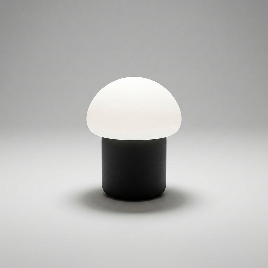 Stylish Mushino LED mushroom lamp casting gentle ambient light on a contemporary desk.