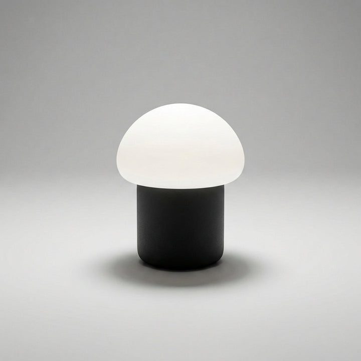 Stylish Mushino LED mushroom lamp casting gentle ambient light on a contemporary desk.