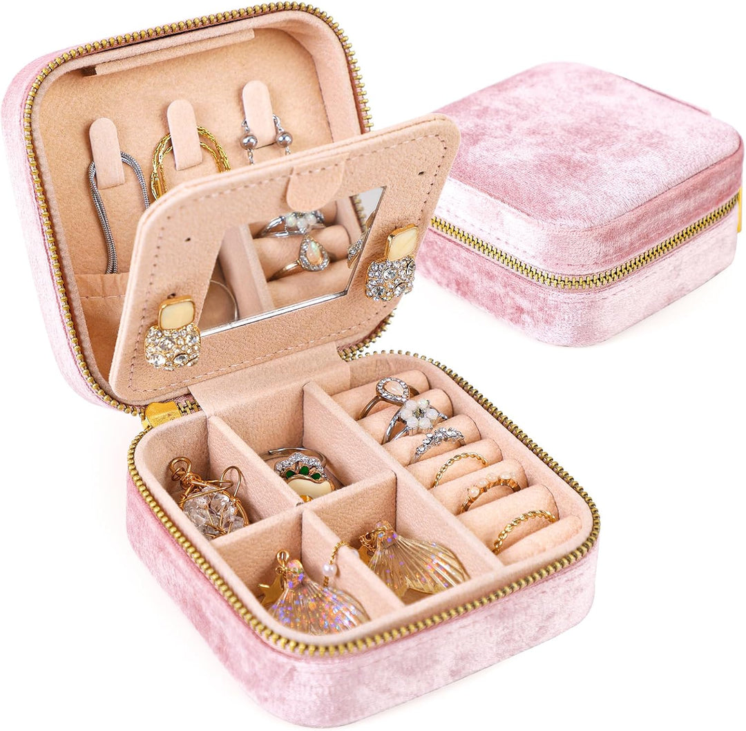 Compact pink velvet travel jewelry box with mirror, ideal for organizing rings, earrings & necklaces on the go.