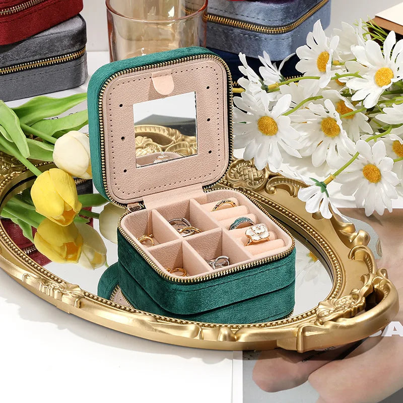 Pink travel jewelry box with mirror, velvet interior for tangle-free storage of rings, earrings & chains.