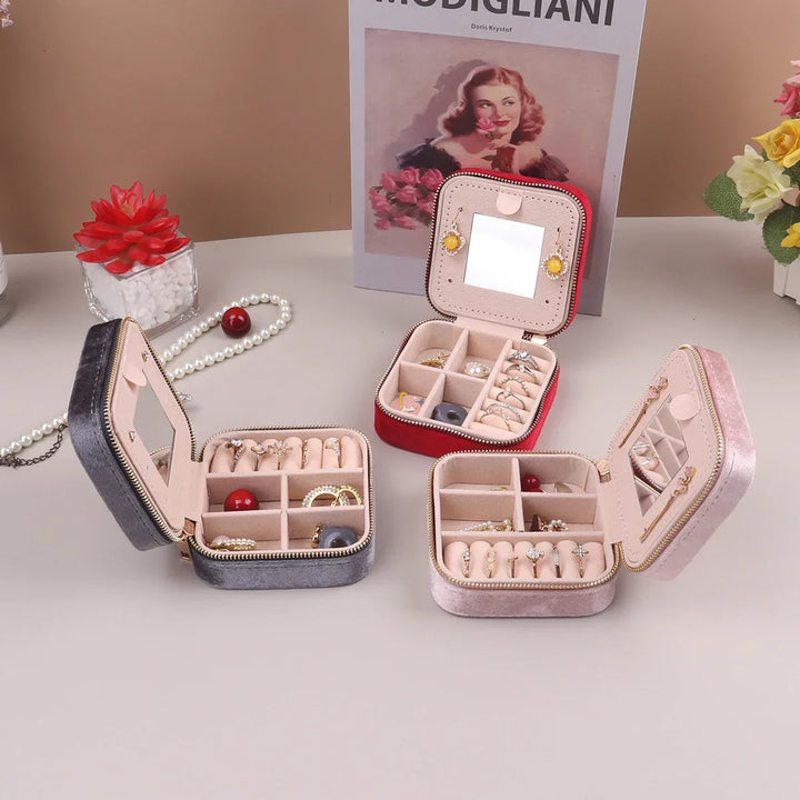 Vibrant red travel jewelry box with mirror, a compact velvet case for storing & organizing accessories.