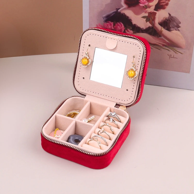 Assorted women's travel jewelry boxes with mirror, velvet organizers in pink, blue, green, gray for accessories.