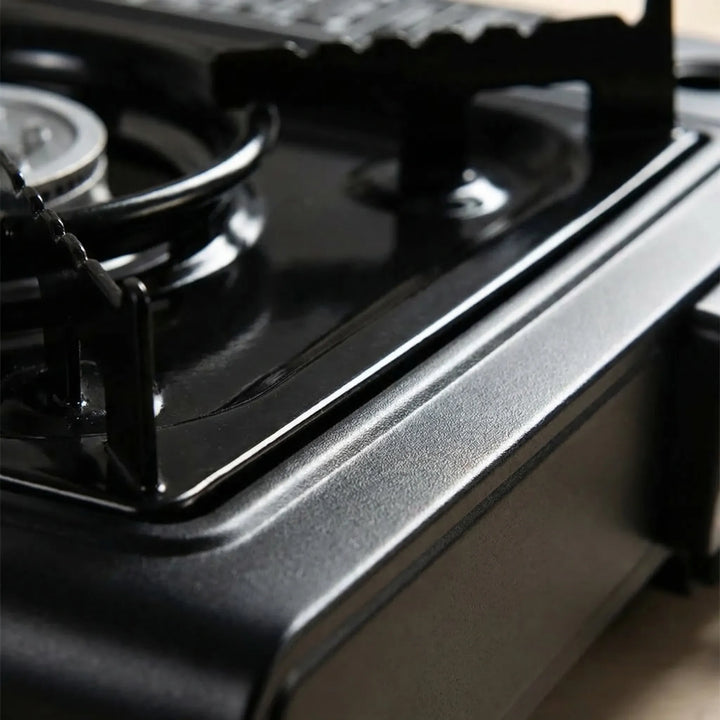 Portable gas stove cooking outdoors, perfect for hiking, picnic gear, and quick camp meals.