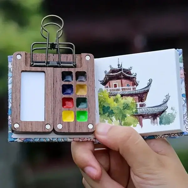 Open compact portable watercolour set showing colorful paint pans, ready for immediate artistic use.
