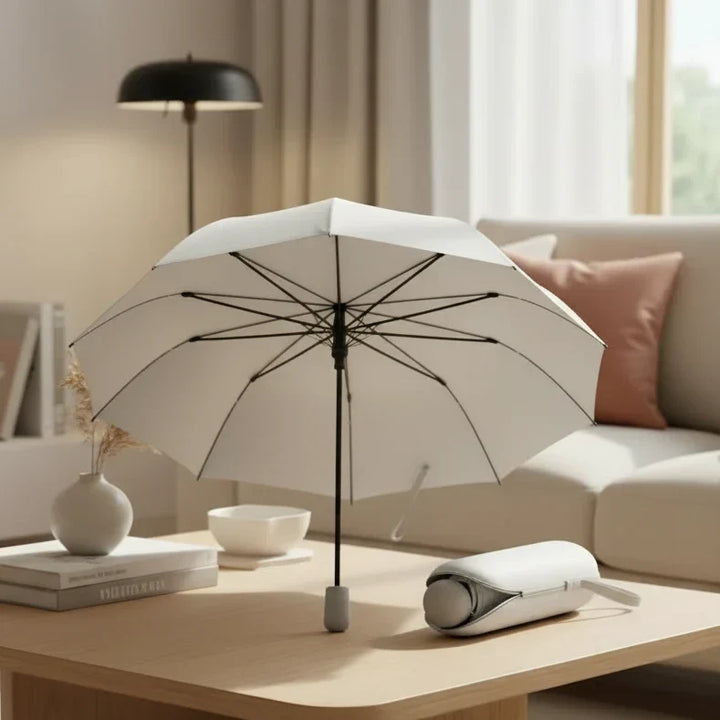 Compact travel umbrella, black, folded neatly, showcasing its ultra-portable design for easy carry.