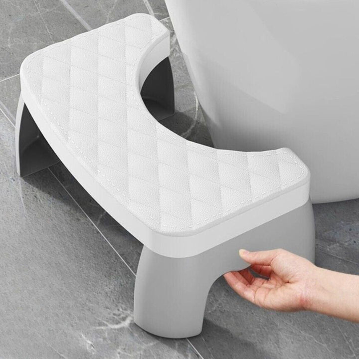 Black compact toilet squat stool with non-slip feet, designed for enhanced comfort and better digestive support.