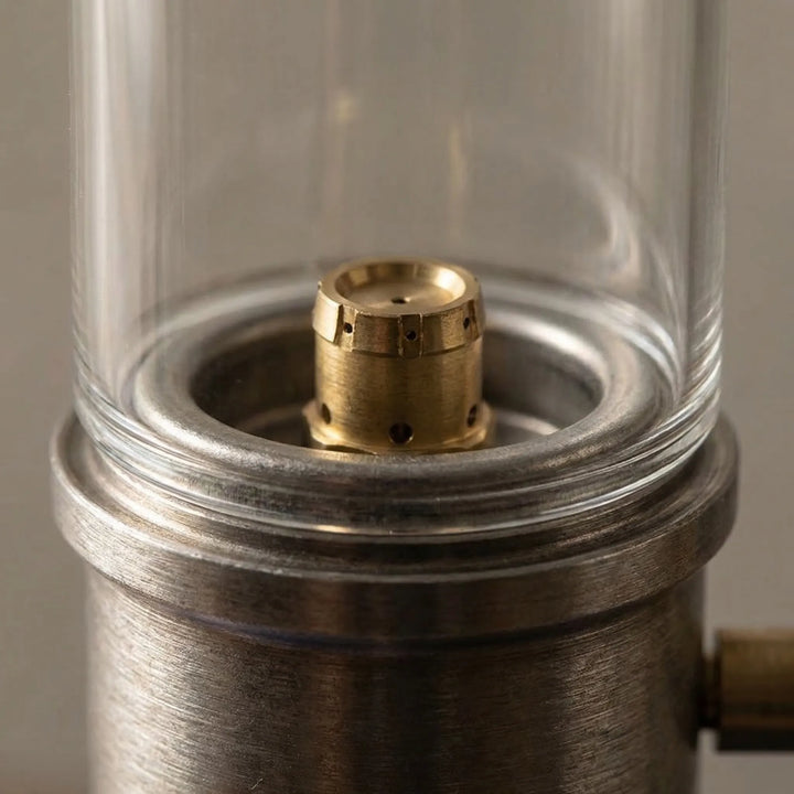 Gas camping lamp with a protective windproof design, creating a cozy candle glow for outdoor ambiance.