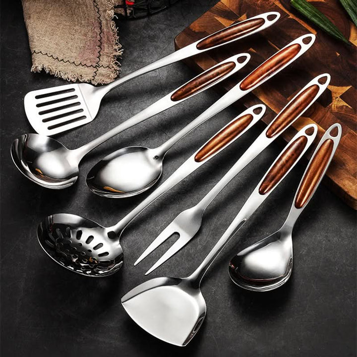 Modern stainless steel kitchen utensil set displayed neatly in a contemporary kitchen. Perfect for home cooking.