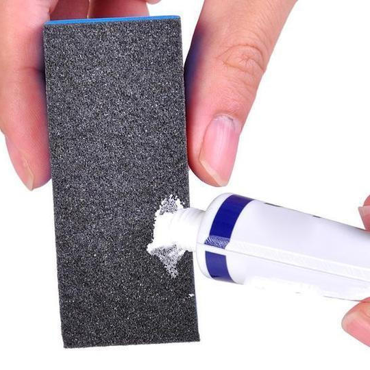 Close-up of Fast Car Scratch Remover bottle and polishing pad, essential for auto paint restoration.