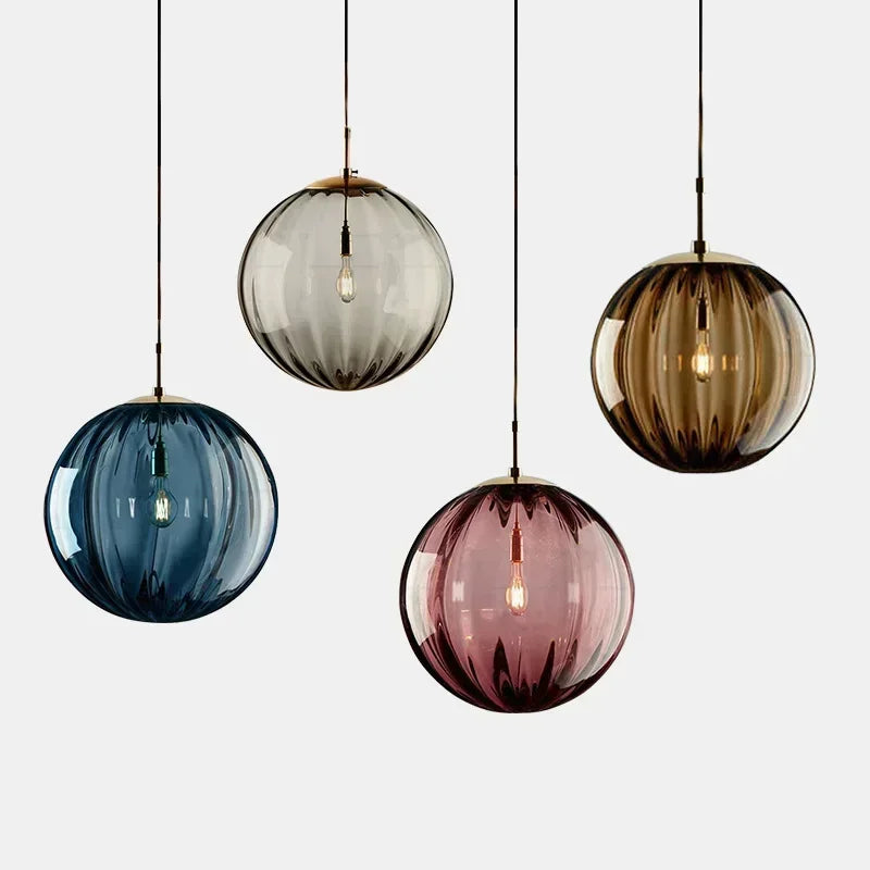 Elegant LED pendant light featuring a clear glass globe, ideal contemporary lighting for dining areas.