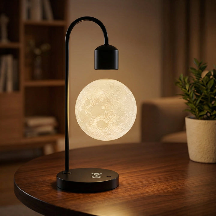 Cordless bedside lamp with levitating 3D printed moon, charging smartphone, soft ambient light.