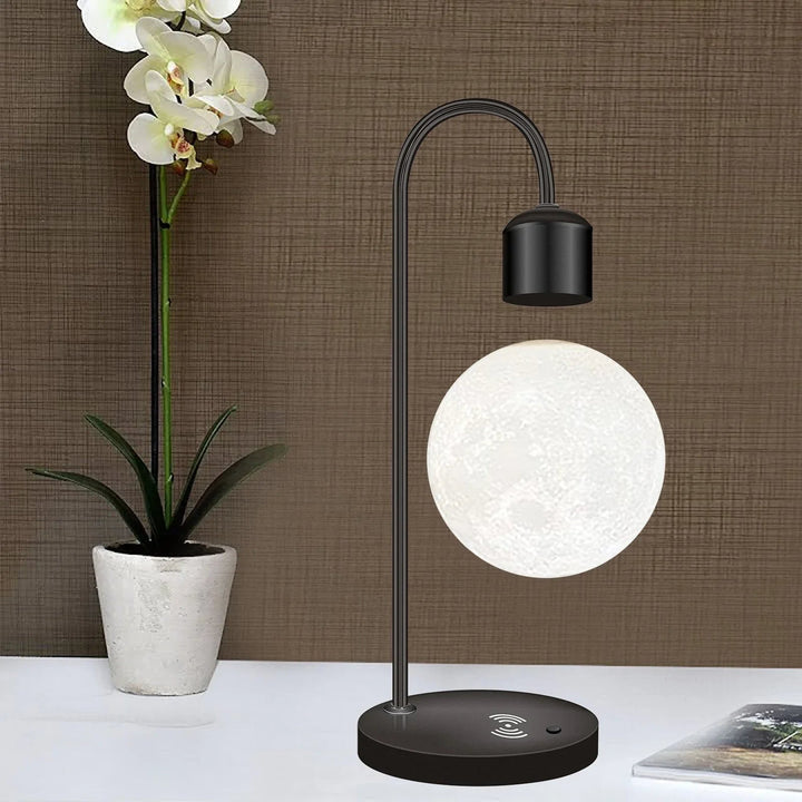 Modern home decor: Wireless bedside charging lamp with a unique floating moon for ambient lighting.