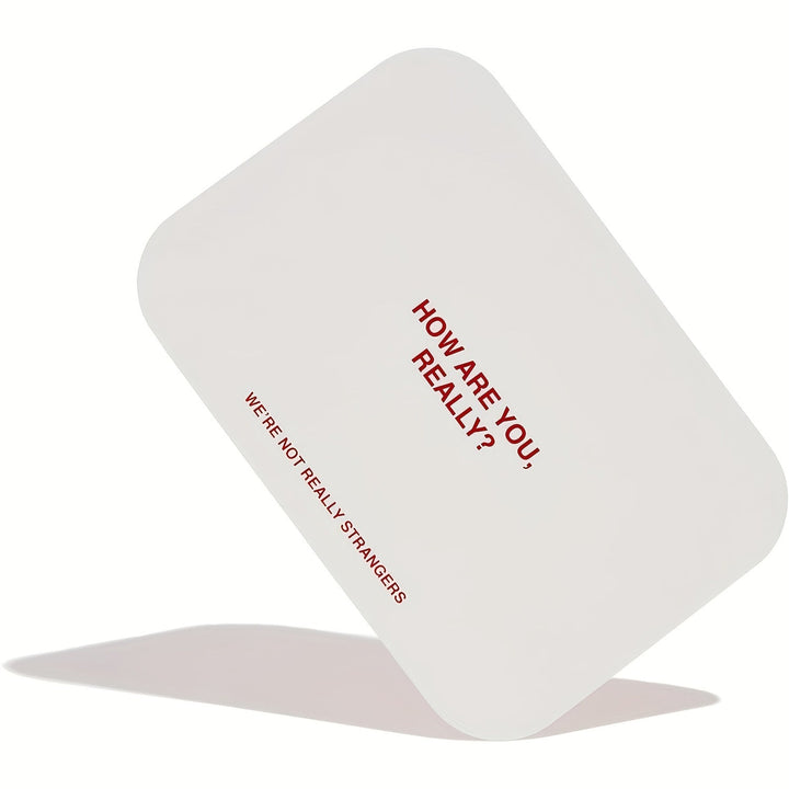 Two hands holding SoulConnect intimacy cards, fostering emotional connection for partners.