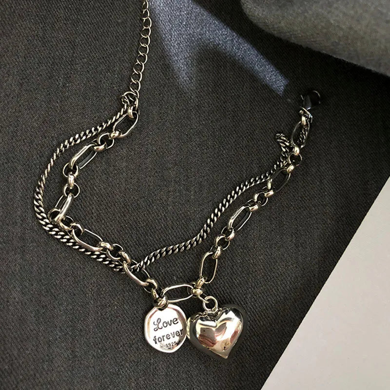 Detail shot of one adjustable stainless steel love bracelet. Part of the couples' matching jewelry set, a romantic gift.