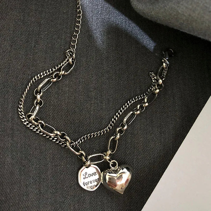 Detail shot of one adjustable stainless steel love bracelet. Part of the couples' matching jewelry set, a romantic gift.