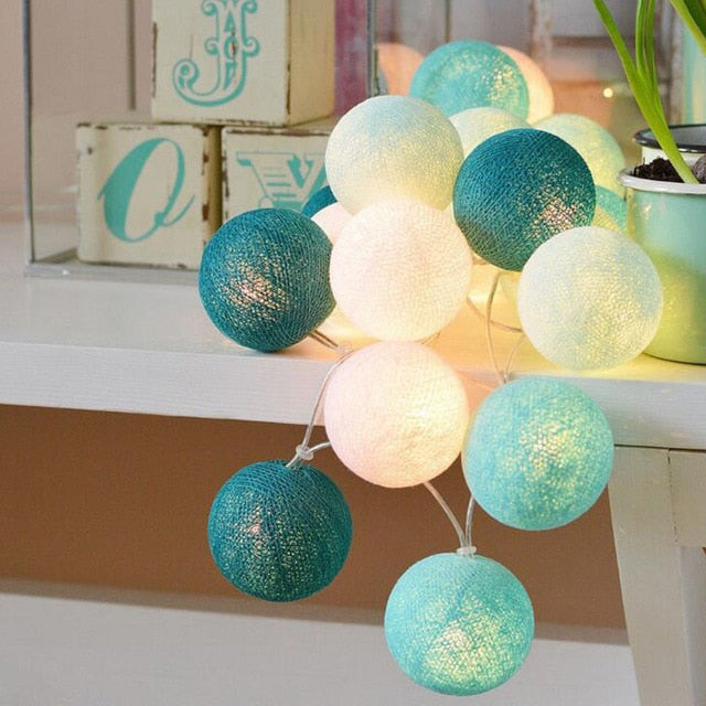 Cozy cotton ball string lights creating warm ambient lighting for indoor home decor.