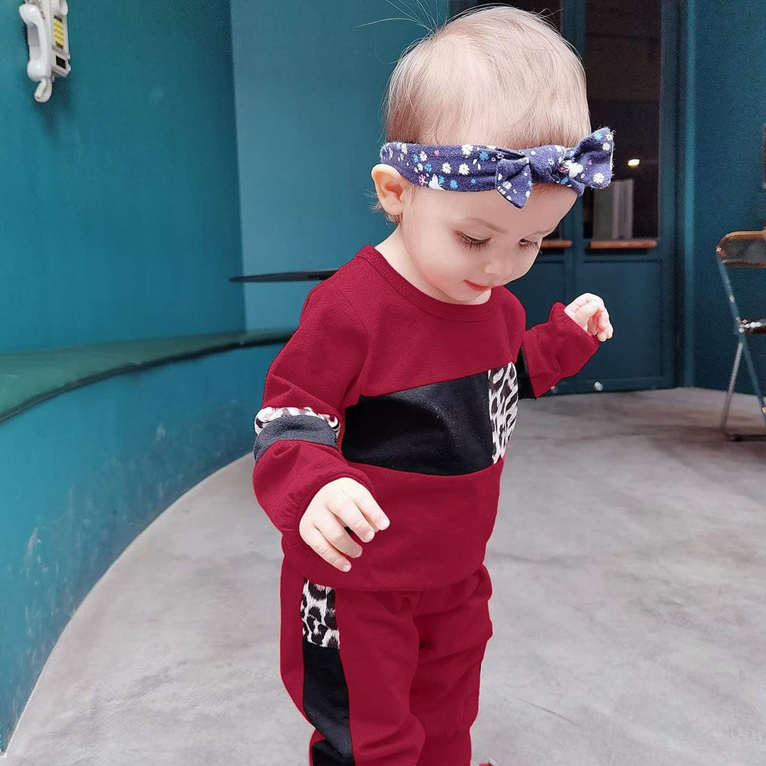 Girls' durable cotton sweater and trouser set, designed for toddler play.