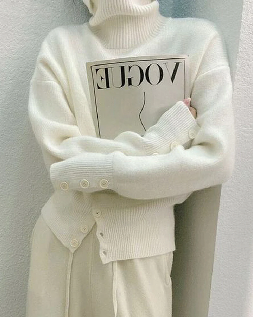 Soft women's ivory turtleneck sweater, a cozy knit long-sleeve top ideal for comfortable everyday wear.