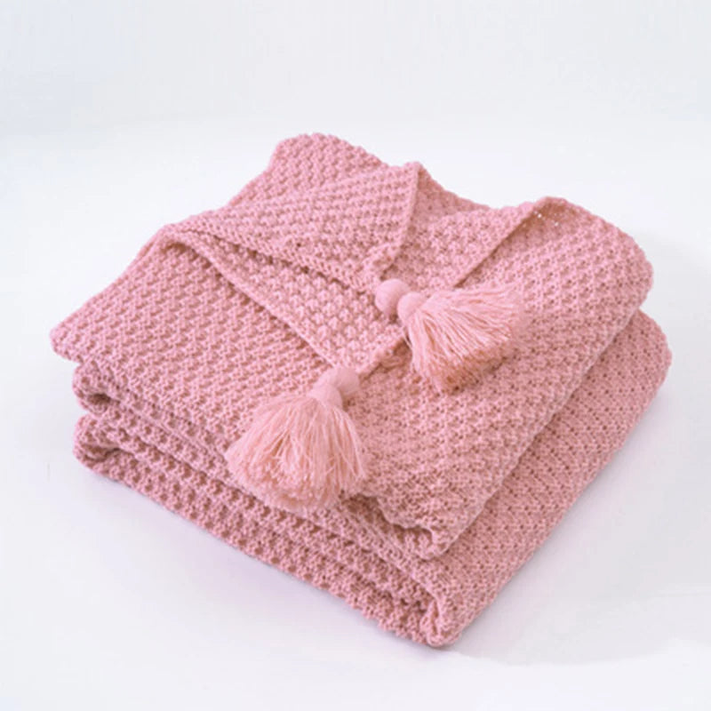 Warm & decorative Aurora knitted wool blanket, ideal for hygge and cozy living spaces.
