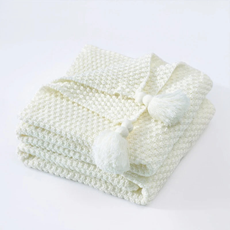 Elegant knitted wool blanket, Aurora style, enhancing any sofa or bed with hygge comfort.