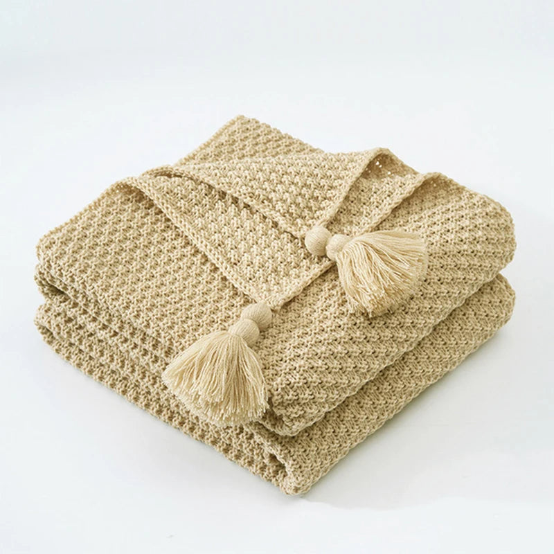 Decorative knitted wool throw for cozy living, a warm accent for sofas and beds.