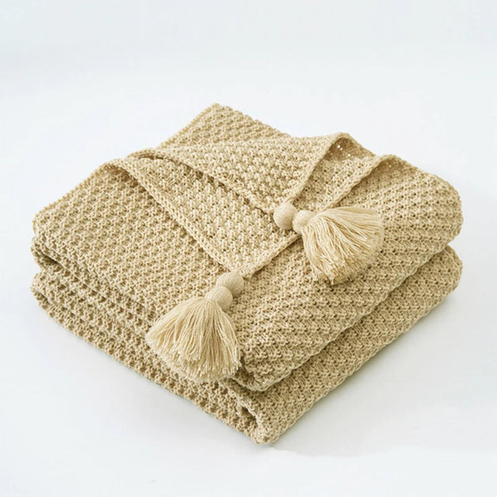 Decorative knitted wool throw for cozy living, a warm accent for sofas and beds.