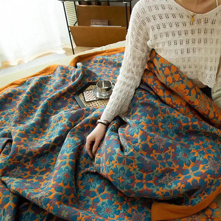 Six-layer cotton quilt featuring a modern orange and blue design, perfect for a cozy bedroom