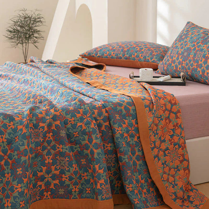 Beautiful patterned cotton quilt in orange and blue, ideal for home textiles and bed decor