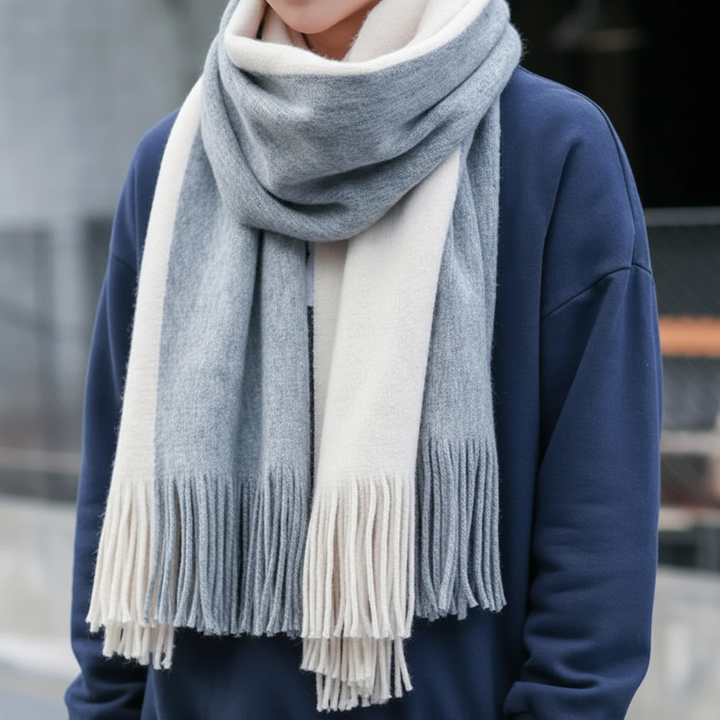 Unisex striped knit scarf featuring a soft texture and playful fringe detail