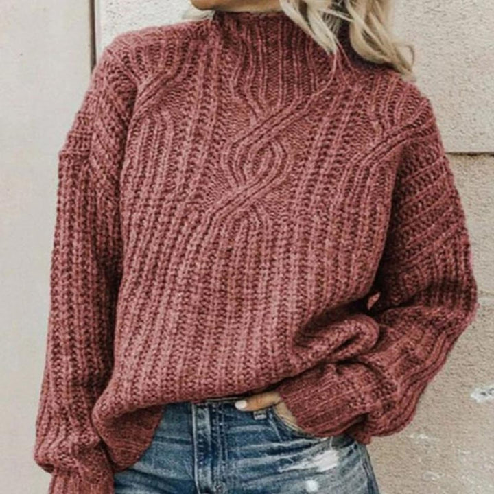 Warm & comfortable women's cable knit roll neck sweater, featuring a stylish chunky knit for cozy wear.