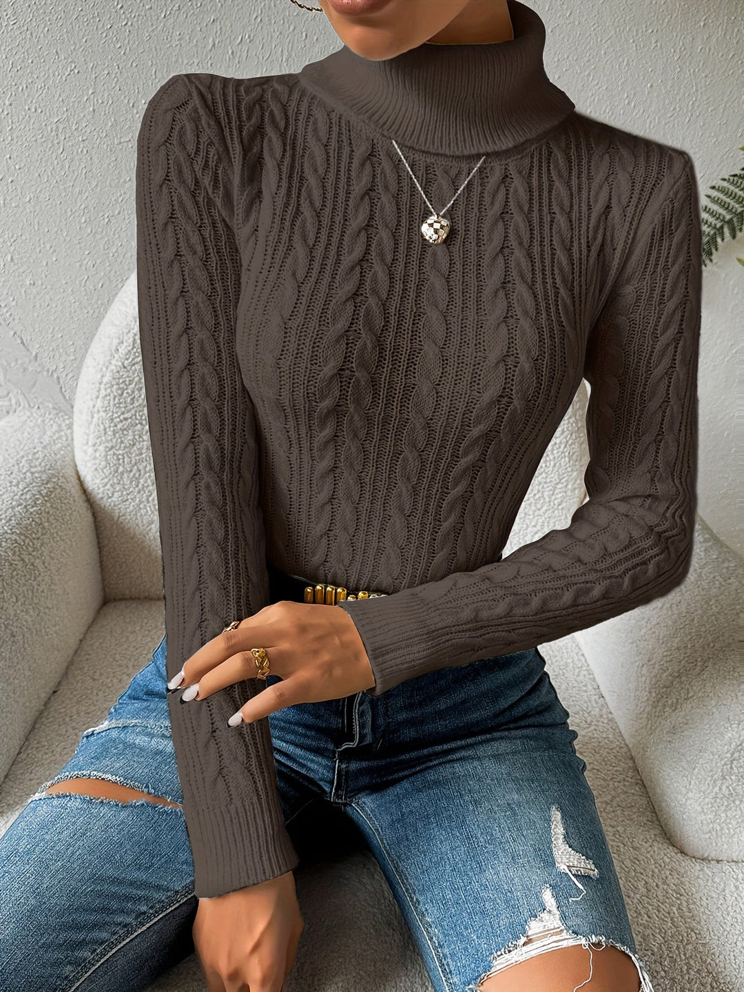 Stylish women's cable knit turtleneck sweater in a cozy design. Ideal for casual winter fashion & warmth.