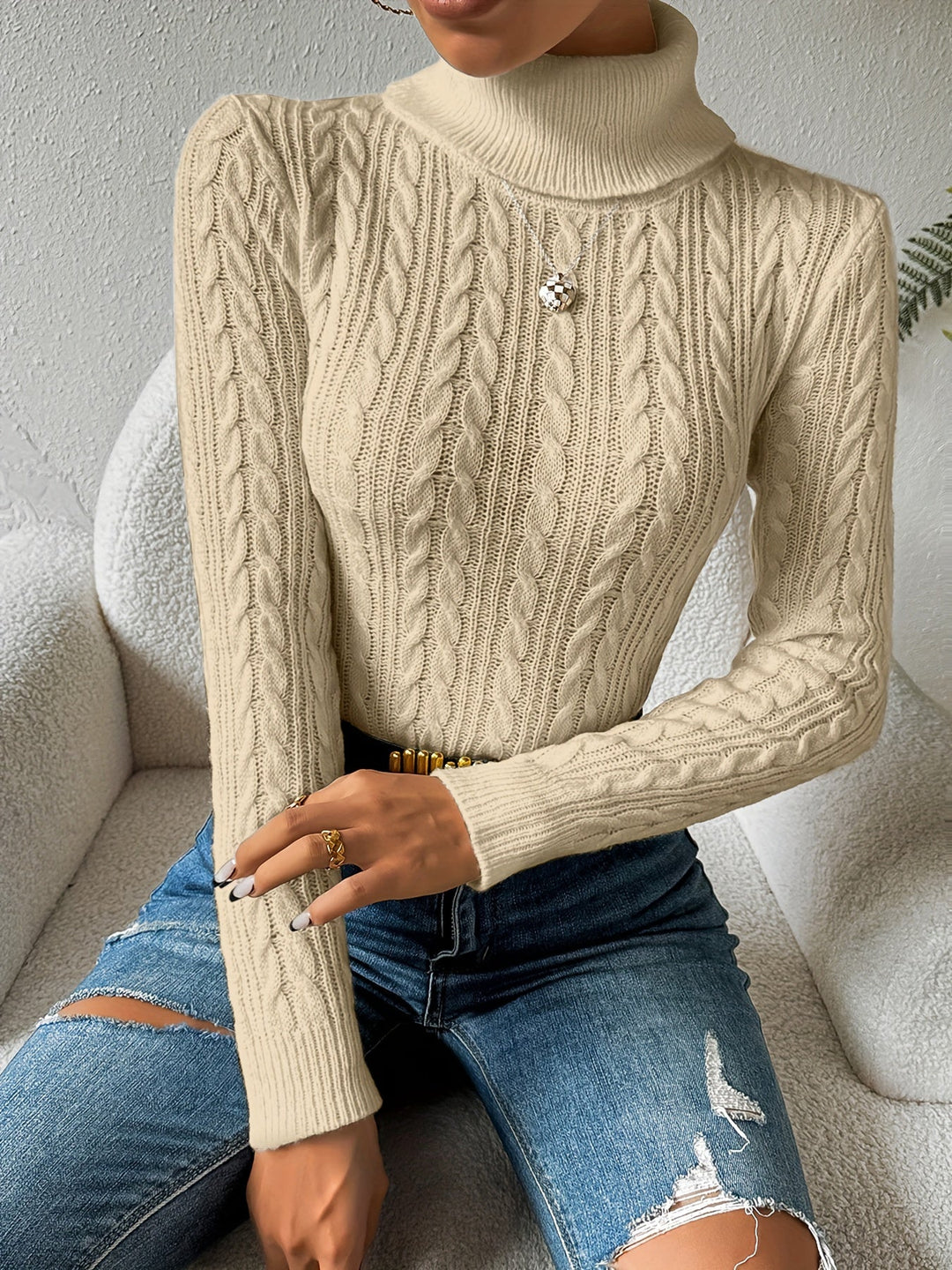 Women's cozy cable knit turtleneck sweater for stylish winter fashion. A versatile long sleeve top for cold weather.