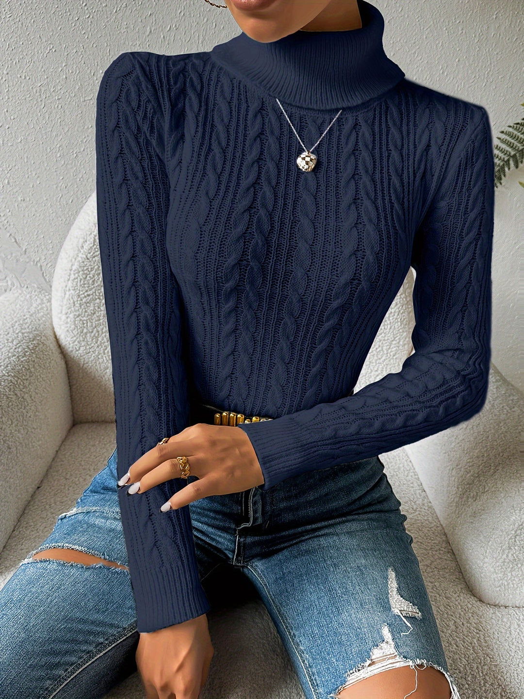 Luxurious women's cable knit turtleneck sweater. Cozy long sleeve knitwear, ideal for stylish winter outfits.