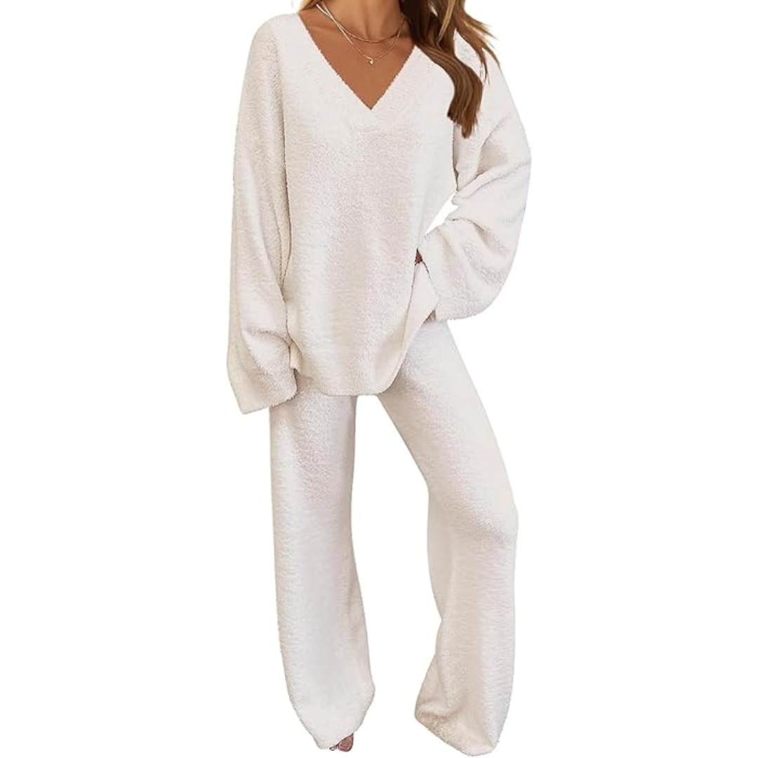 Woman enjoying a hot drink while wearing a cozy fleece lounge set, depicting warmth and comfort.