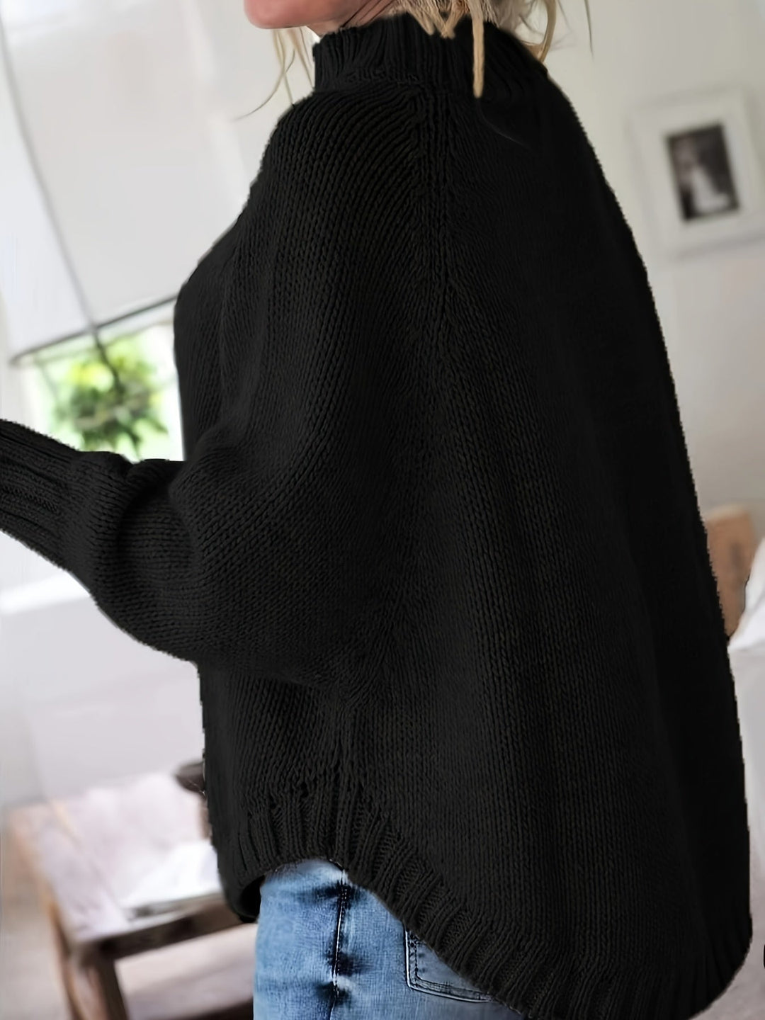 Women's high-neck textured sweater featuring batwing sleeves, flared hem, and oversized fit for fall.